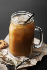 Iced coffee in glass jar on black table