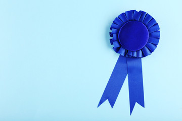 Blue award prize ribbon on blue background