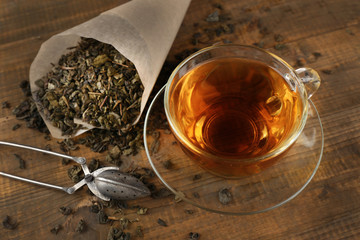 Cup of black tea on wooden table