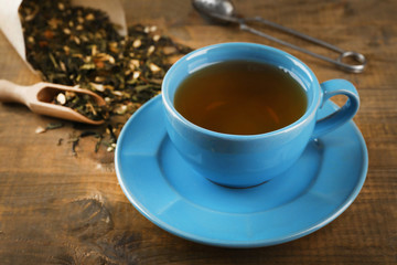 Cup of black tea on wooden table