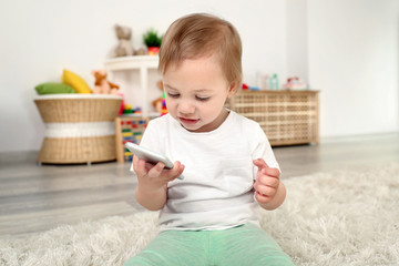 Cute baby girl playing with a smartphone