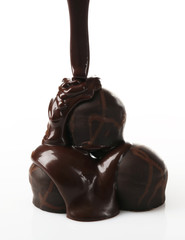 Melted chocolate with candies, isolated on white