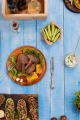 Steak grilled with stuffed zucchini, vegetables and sauce