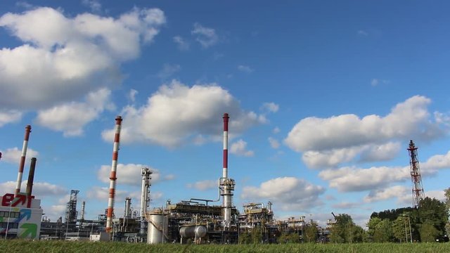 Oil refinery in sunny beautiful weather with clouds in background
