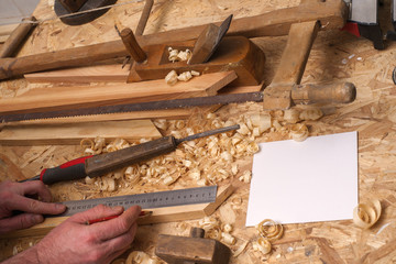carpenter working,hammer,meter and screw-driver on construction background
