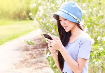 woman in garden using a mobile telephone