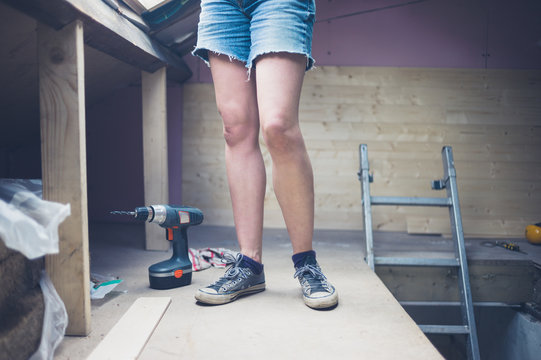 Legs of young woman on building site