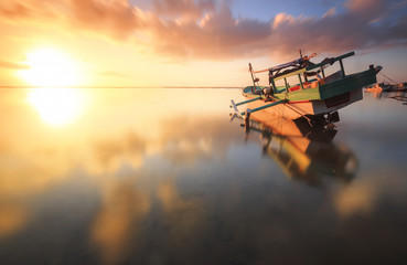 Fototapeta na wymiar Traditional fisihing boats (outrigger canoes) moored off Bali's Tuban Beach, Indonesia.