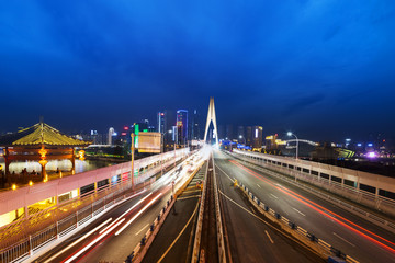 busy traffic on bridge near downtown of chongqing at twilight