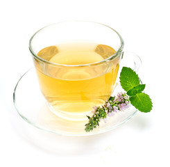 Cup of green tea with mint leaves and flower