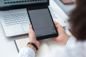 Young women using digital tablet in the office.