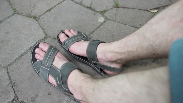 Man's feet in sandals/summer sitting man in sandals
