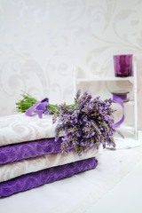 Stack of bath towels with fresh lavender flowers