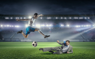 Obraz na płótnie Canvas Businessman and player fighting for ball . Mixed media