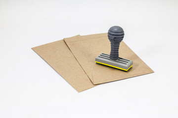  rubber stamps and brown envelops on white background 