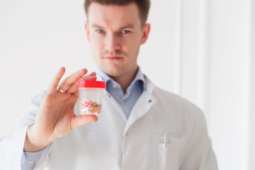 Doctor hands holding with jar of capsules