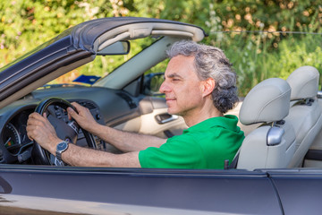 thoughtful man on convertible car