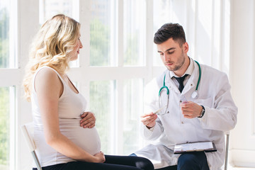 Doctor is measure the temperature of pregnant woman