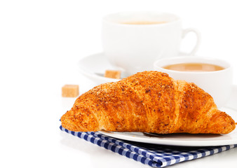 Breakfast with fresh croissants, cup of coffee and honey on a wh