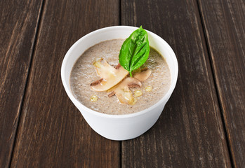 Hot food delivery - mushroom soup at wood