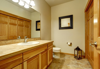 Light brown bathroom with marble tile floor and beige walls.
