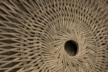 The back of a bamboo woven container 