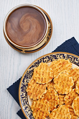 Cheese Caraway Crackers With Coffee on a White Wooden Table