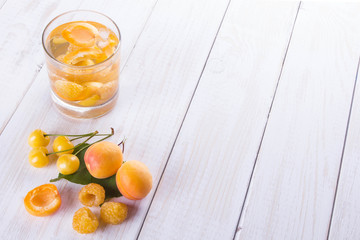 cold drink with cherries apricots and raspberries standing on a