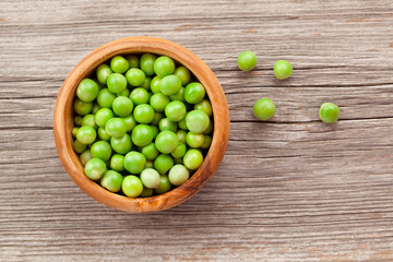 fresh green pea in bowl on wooden background