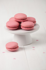 Macaroons Biscuits On White Stand. Paper Hearts