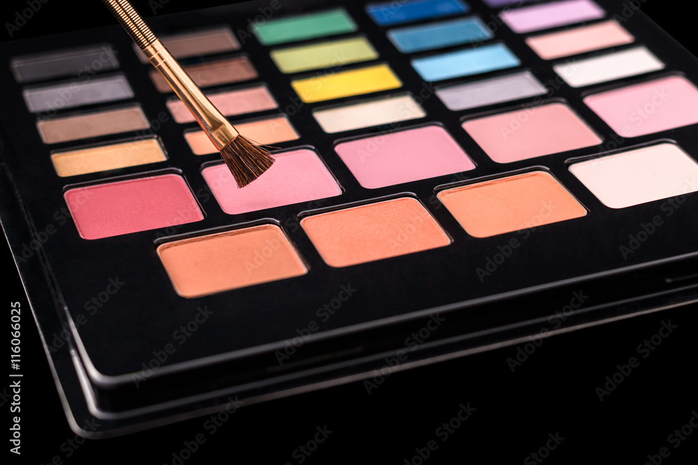 Wall mural Makeup palette of colorful eyeshadows with makeup brush isolated