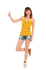 Obraz premium Girl Standing On One Leg And Showing Thumb Up