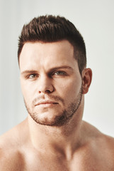 Obraz premium Closeup portrait of a young handsome guy, isolated on white, side-view