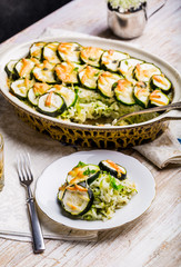 Casserole with zucchini, rice and cheese served with fresh basil