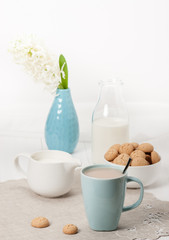 Hyacinth Flowers In Vase. Amaretti Biscuits. Cup Of Tea