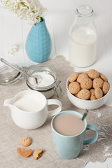 Hyacinth Flowers In Vase. Amaretti Biscuits. Cup Of Tea