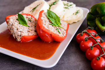Red pepper stuffed with rice, minced meat and vegetable in tomato sauce with steamed dumpling