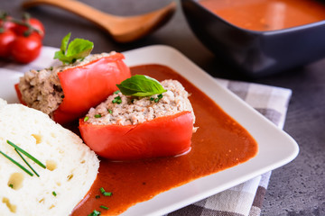 Red pepper stuffed with rice, minced meat and vegetable in tomato sauce with steamed dumpling