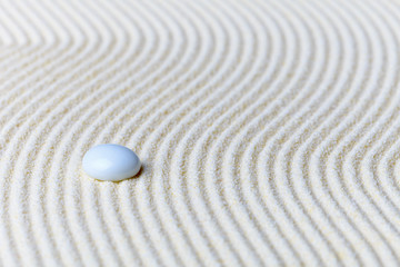 Fototapeta na wymiar Abstract composition, glass drop on sand - Zen Garden