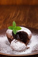 Homemade hot chocolate pudding with fondant center , lava cake on wooden background