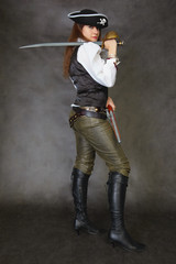 Woman dressed as pirate on black with sword