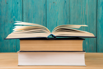 Open book on the desk over wooden background