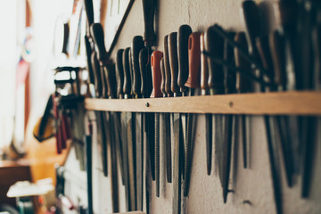 Wood rasp files hanging on wall in attic