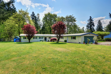 Exterior of American rambler house with grass filled front garden