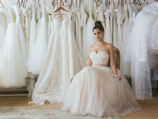 Bride wearing wedding dress in tailor shop