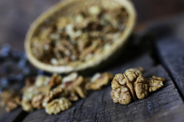 Fototapeta na wymiar peeled walnut on a wooden background