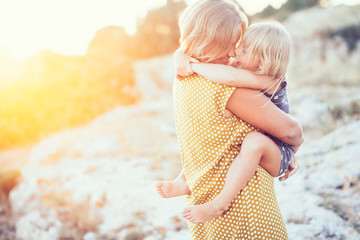 Mom playing with child in sunlight