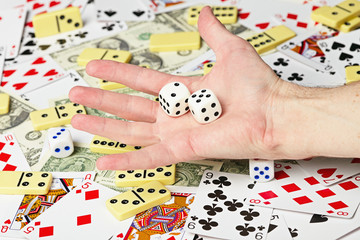 Dice on palm on the background cards and money