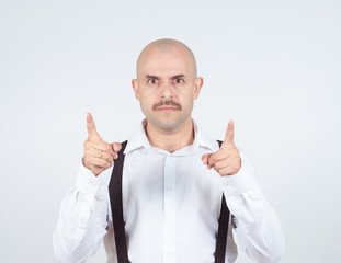 Bald businessman pointing at the camera with.
