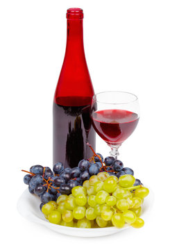Bottle of red wine, glass and grapes on white background